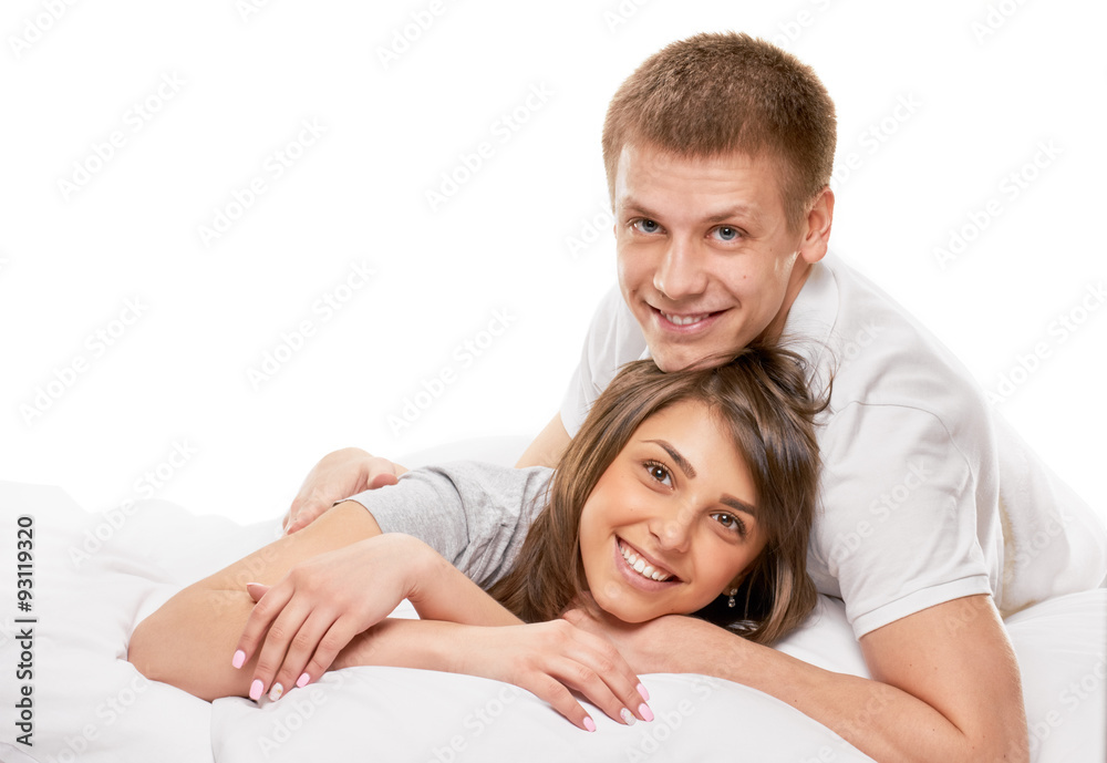 Couple lying in bed smiling Couple lying in bed smiling
