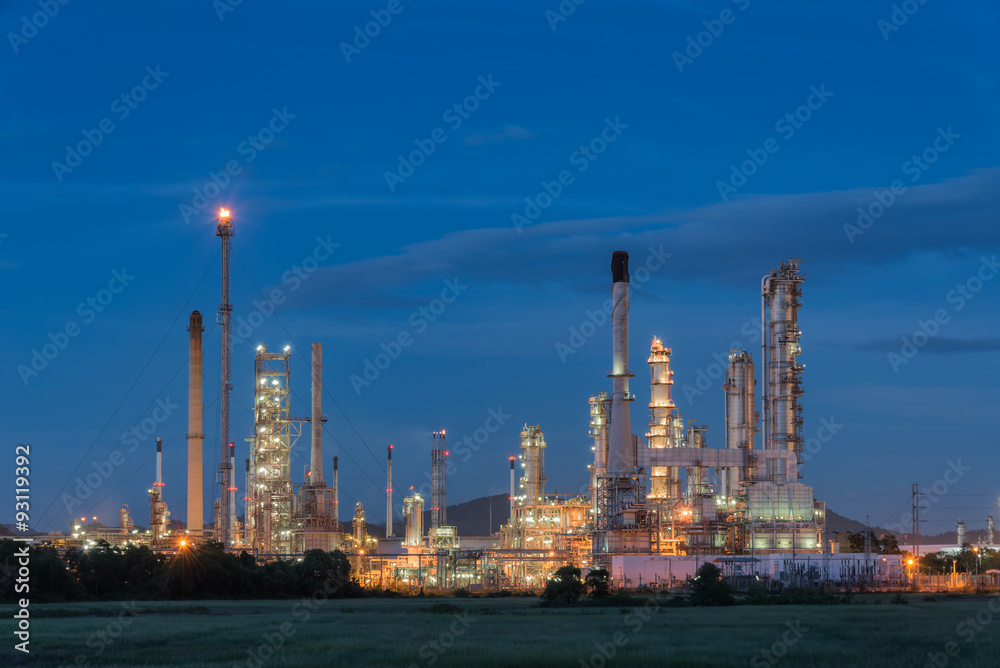 Oil refinery at twilight with sky background.