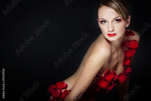 Sexy woman are posing in flowers 
