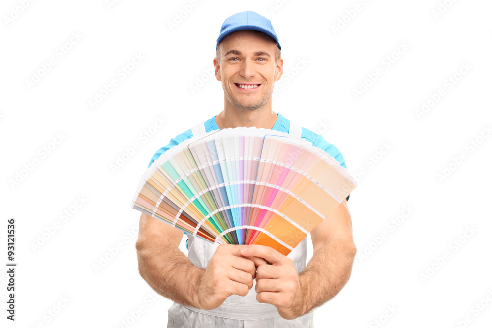 Young male painter holding a color palette guide Young male painter holding a color palette guide
