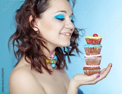 portrait of beautiful woman with cakes 