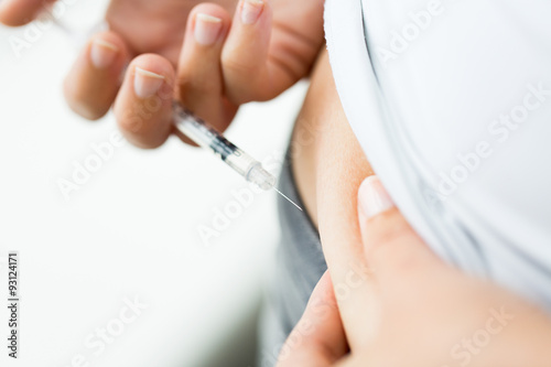 woman with syringe making insulin injection