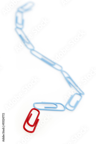 Red paper clip at the head of blue paper clip chain. Leadership concept.