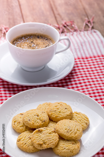 cookies on white plate and cup of coffee