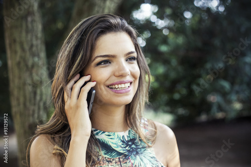 Beautiful girl smiling using a mobile phone 