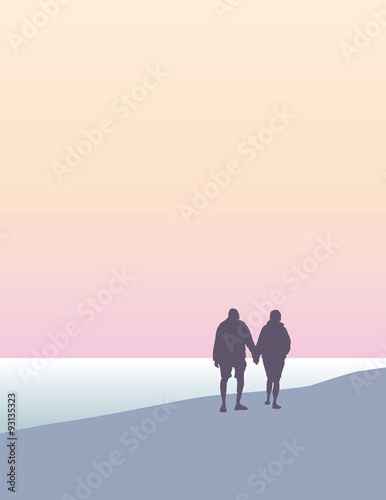 A man and woman walking on the beach
