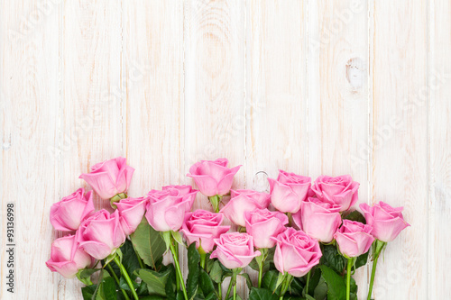 Pink roses bouquet over wooden table © karandaev