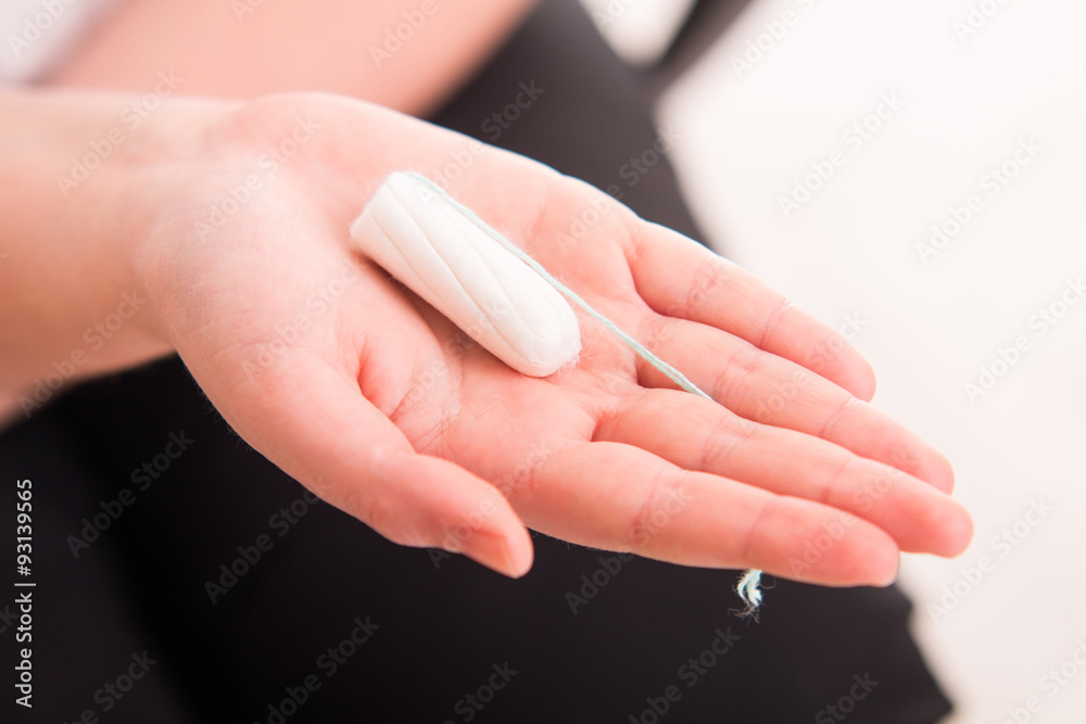 Tampo on womans hand before intravaginal aplication Tampo on womans hand before intravaginal aplication