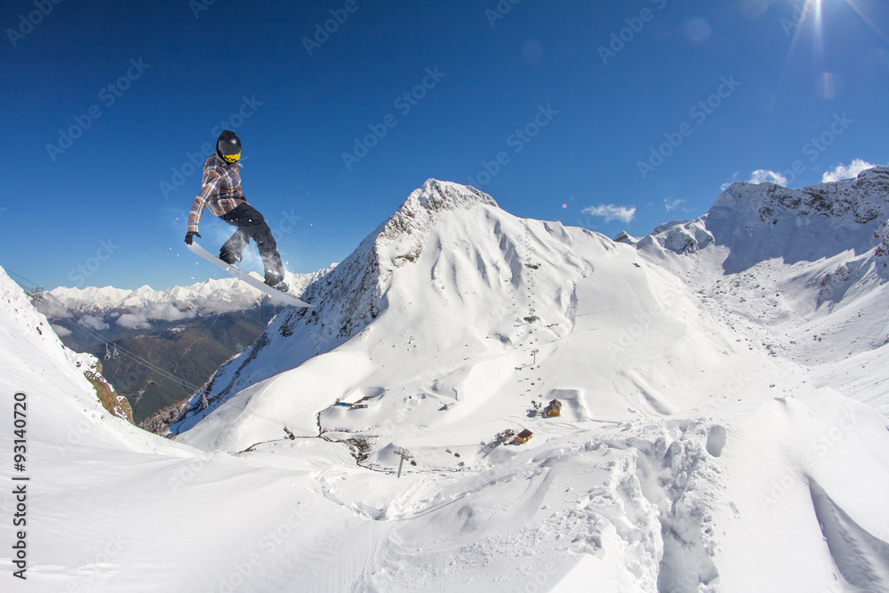 Flying snowboarder on mountains