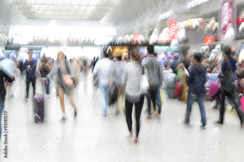Traveler silhouettes in motion blur, airport interior