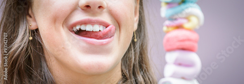 panoramic view of pretty young girl eating a delicious marshmallow skewer