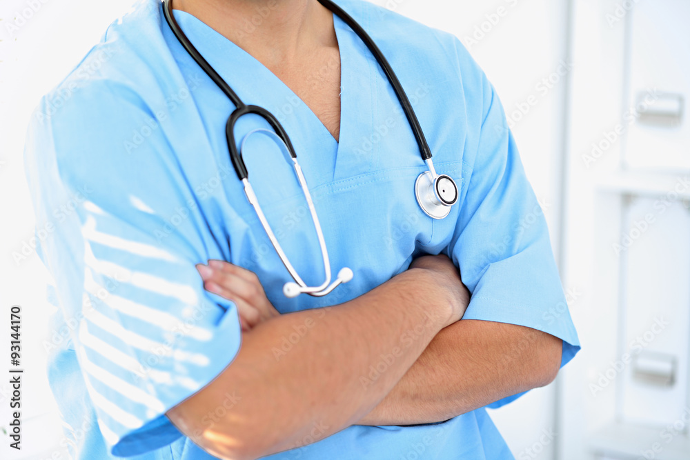 Portrait of unknown male surgeon doctor holding his stethoscope, crossed arms Portrait of unknown male surgeon doctor holding his stethoscope, crossed arms