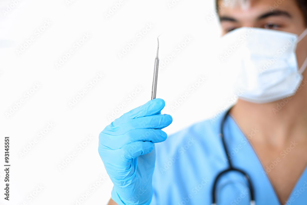 Portrait of unknown male surgeon doctor with stethoscope, holding surgeon object Portrait of unknown male surgeon doctor with stethoscope, holding surgeon object