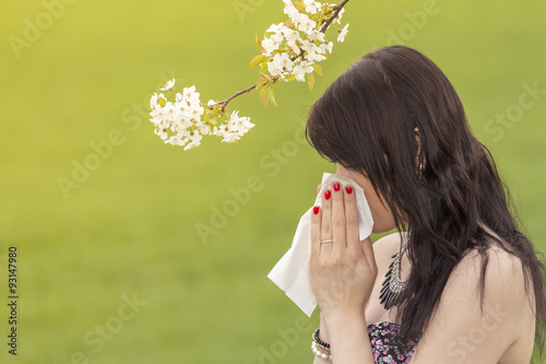 Konstfotografi Beautiful hayfever girl wiping her nose in spring nature