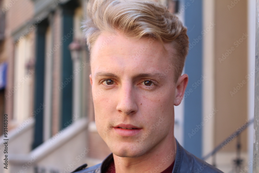 close portrait of handsome adult blonde man, with blured urban classic background close portrait of handsome adult blonde man, with blured urban classic background