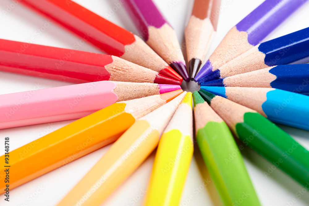 Set of multicoloured pencils lying on white table round order Set of multicoloured pencils lying on white table round order