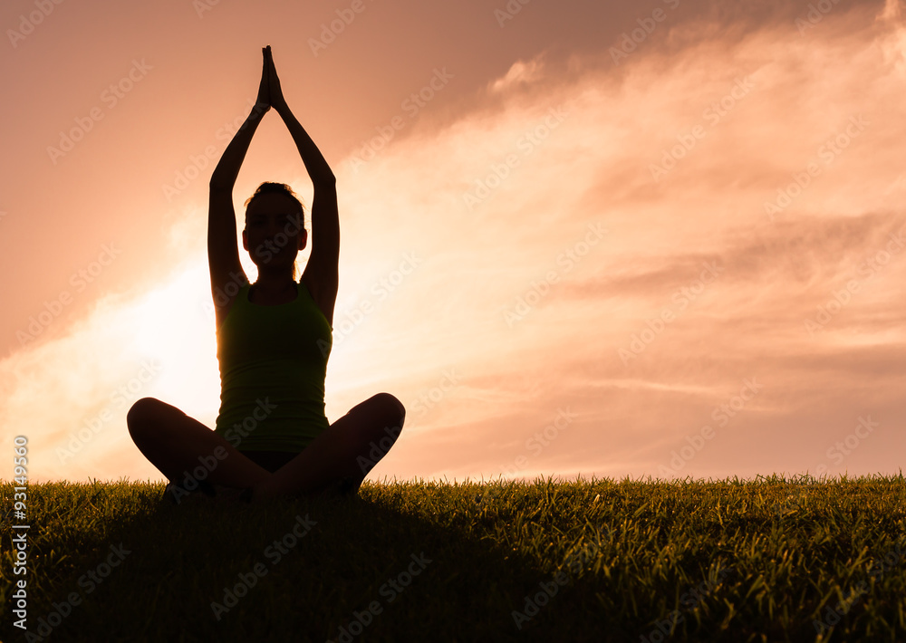 Woman meditating in a yoga pose outdoors