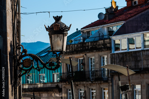 old street lamp, roofs and windows in Vigo, Spain