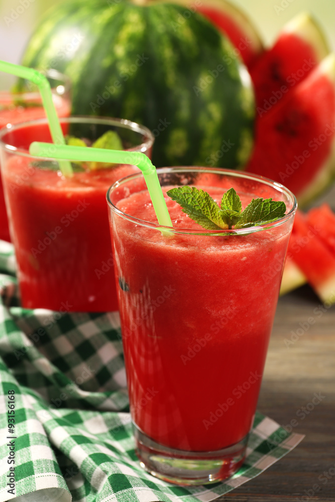 Glasses of watermelon juice on wooden table, closeup
