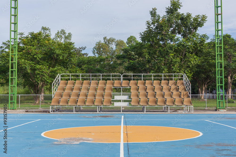 Small empty old brown grandstand with seating