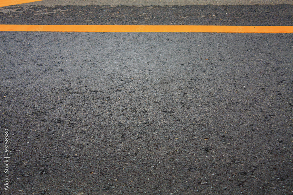 Fototapeta premium Asphalt road texture background with yellow dashed line