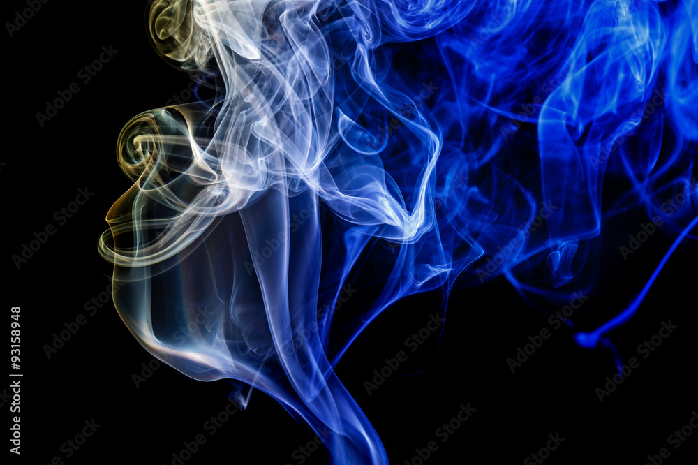 Abstract blue and yellow smoke from the aromatic sticks.