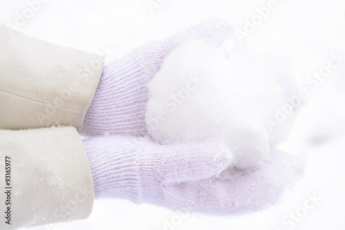 Hand in mittens and snow