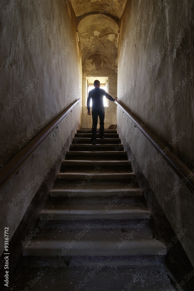 Man silhouette on an old abandoned staircase
