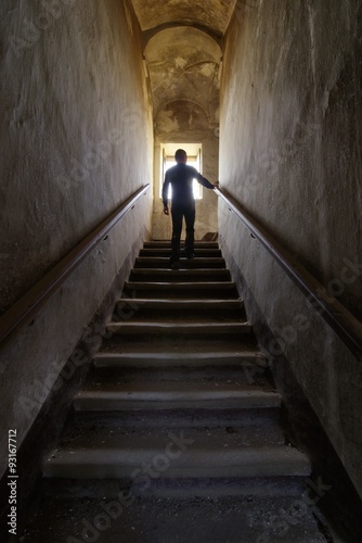 Man silhouette on an old abandoned staircase
