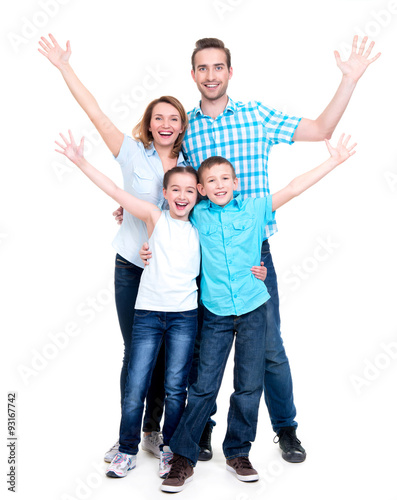 Young happy family with children raised hands up