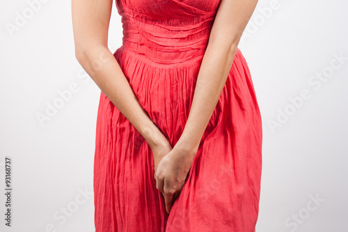 Close up of a woman with hands holding her crotch