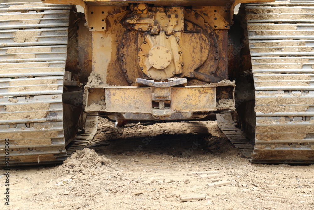 The tracks of a bull dozer excavating machine.