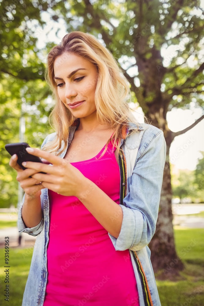 Happy woman using smartphone in park Happy woman using smartphone in park