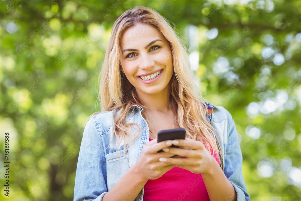 Portrait of smiling woman while holding smartphone Portrait of smiling woman while holding smartphone