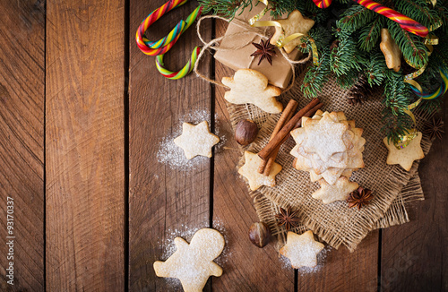 Christmas cookies and tinsel on a dark wooden background. Top view