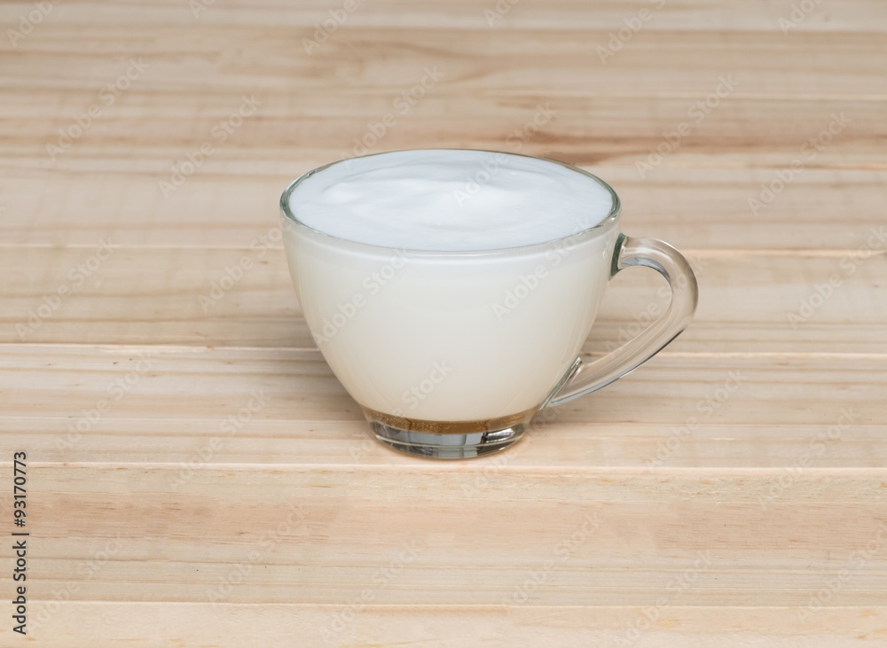 Hot milk on wood texture background Hot milk on wood texture background