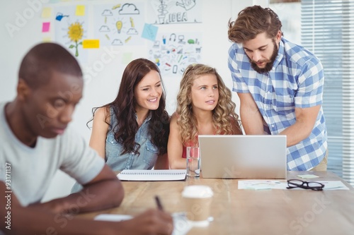 Man discussing with women at desk 