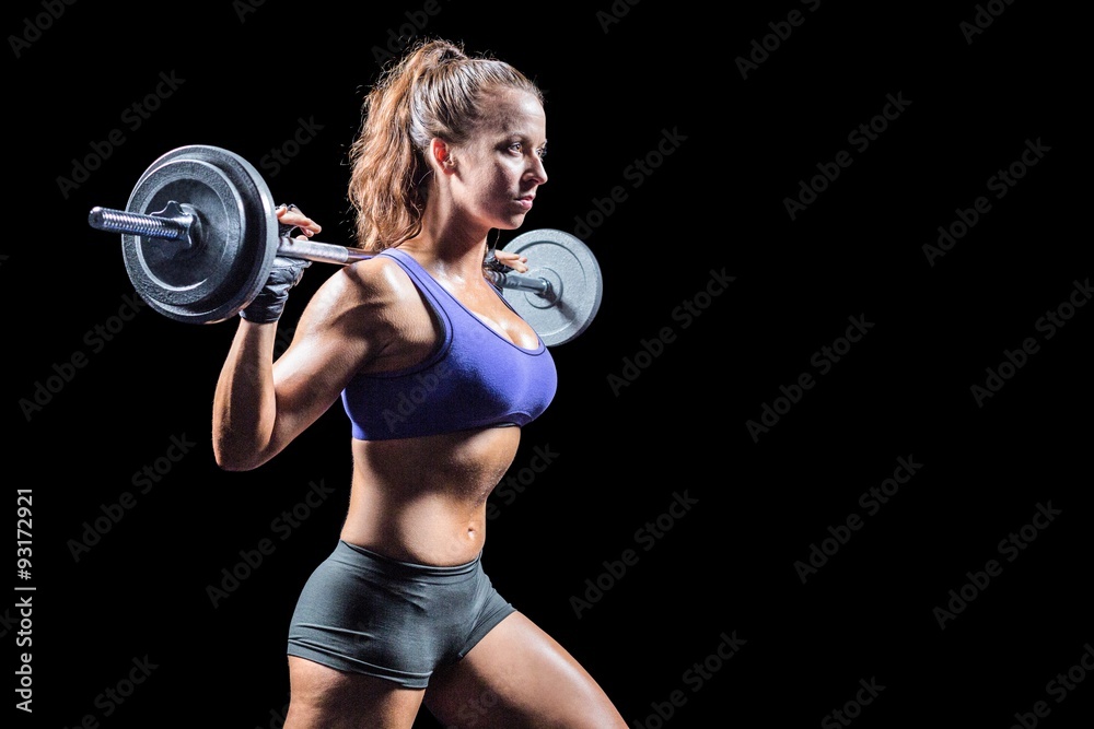 Side view of woman exercising with crossfit Side view of woman exercising with crossfit