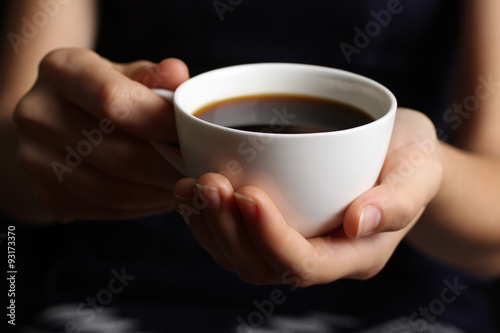 hot coffee in the Cup in the hands of the girl