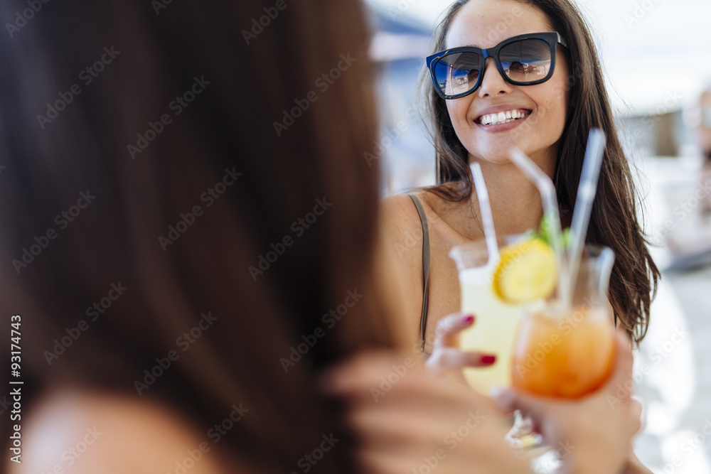 Cheerful female friends drinking cocktails Cheerful female friends drinking cocktails