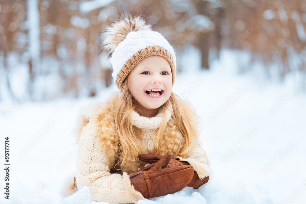 Little girl enjoying a day out playing in the winter forest Little girl enjoying a day out playing in the winter forest