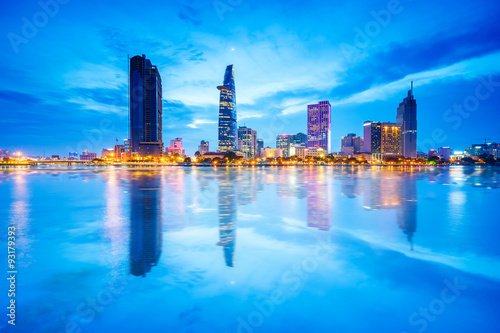 Reflection of night view of Business and Administrative Center of Ho Chi Minh city on Saigon riverbank, Vietnam. Ho Chi Minh city (aka Saigon) is the largest city and economic center in Vietnam.