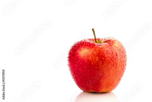 Red apple with water drops.