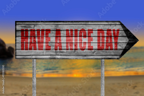 Red Have a Nice Day wooden sign with on a beach background