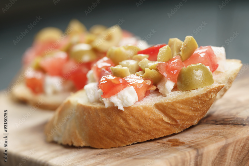 crostini with tomato, mozzarella and olives