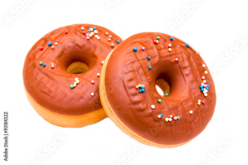 Donuts with chocolate and colored sugar on white background