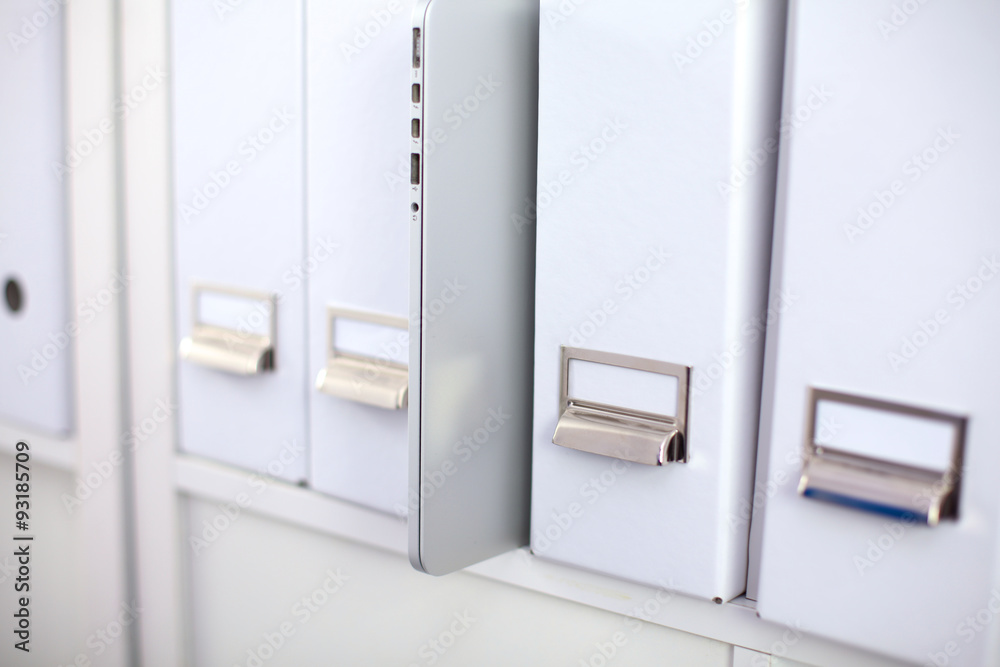 File folders, standing on shelves in the background File folders, standing on shelves in the background