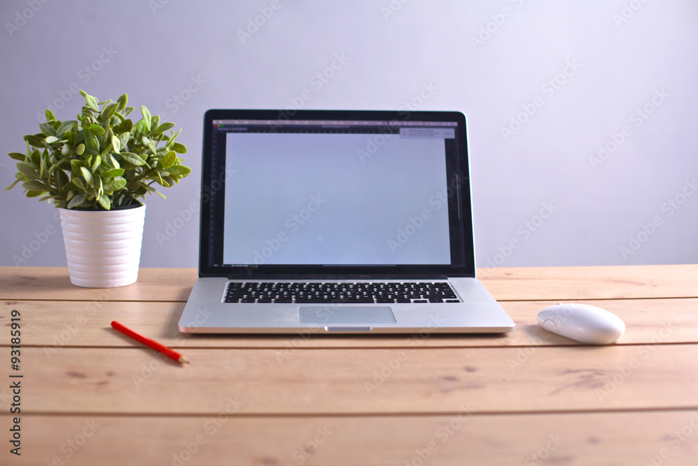 Laptop stands on a wooden table Laptop stands on a wooden table