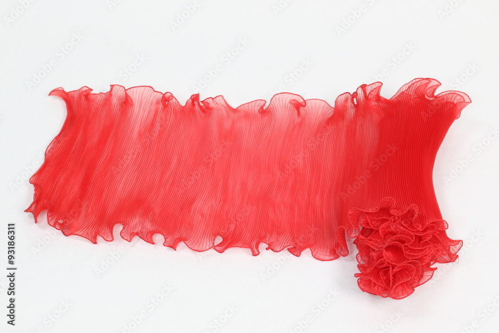 Pressing a red chiffon on a white background.