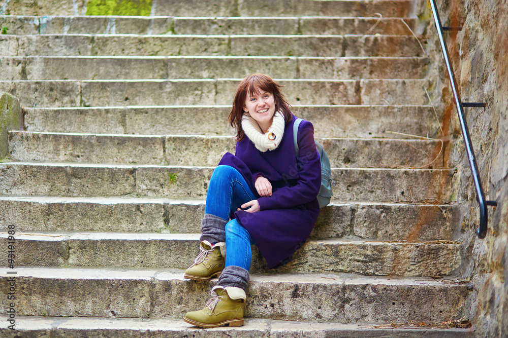 Young tourist in Paris, sitting on the stairs on Montmartre Young tourist in Paris, sitting on the stairs on Montmartre